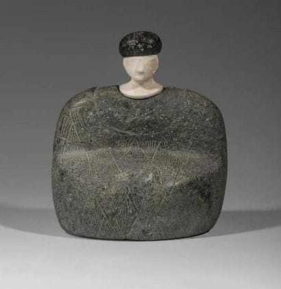 Composite statuette. The character is sitting,...