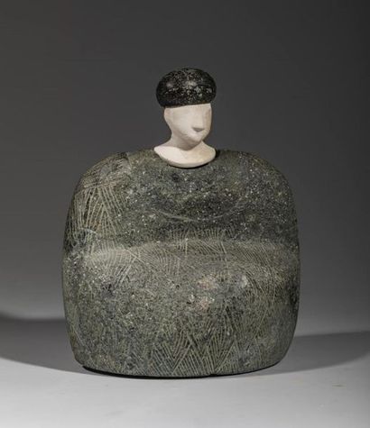 Composite statuette. The character is sitting,...