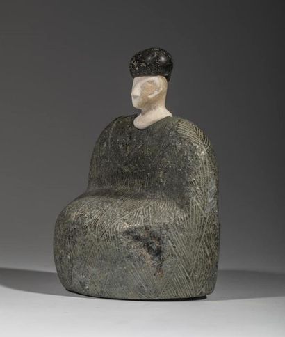Composite statuette. The character is sitting,...