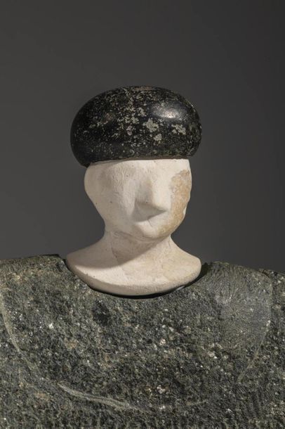Composite statuette. The character is sitting,...