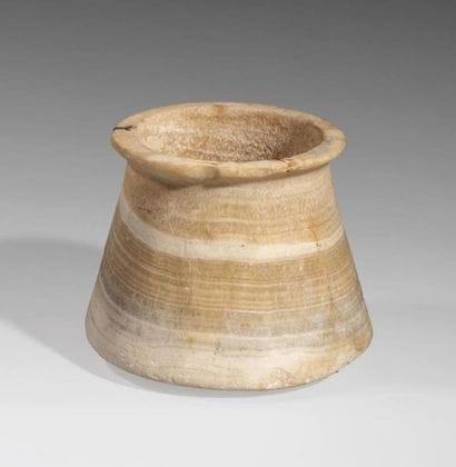 Calcite vase ribboned, flared at the base...