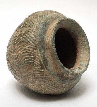 Ball vase in grey shale with carved waves...