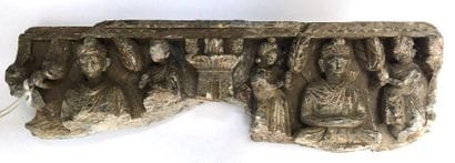 Fragment of a schist frieze carved by Buddhas....