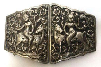 Silver belt buckle decorated with a tara...