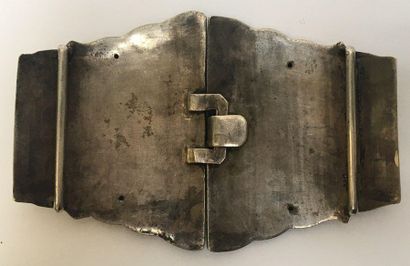 Silver belt buckle decorated with a tara...