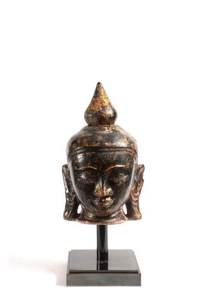 Buddha head in black lacquered sandstone....