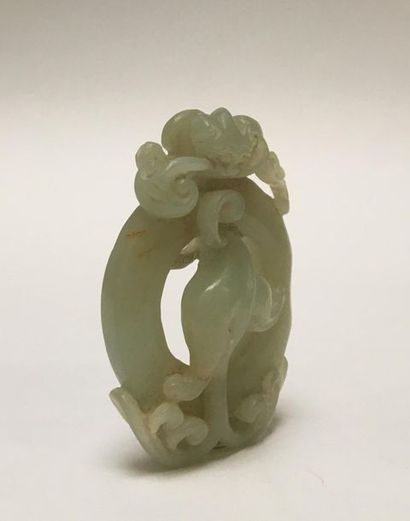 Pale green jade pendant. It represents a...