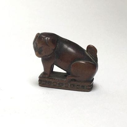 Dog (Sharpeï) made of huanyang wood sitting...