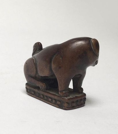 Dog (Sharpeï) made of huanyang wood sitting...