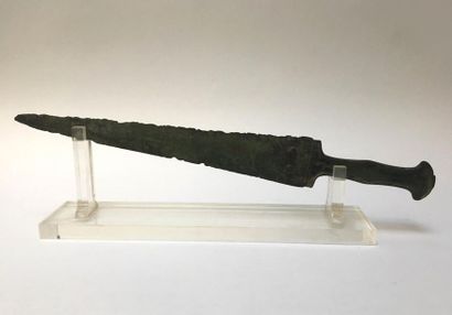 Bronze dagger with green patina. Guard decorated...