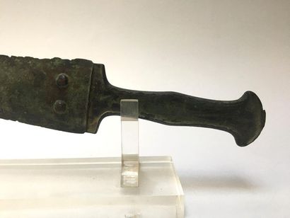 Bronze dagger with green patina. Guard decorated...