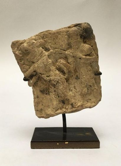 Clay plate representing a man holding a leaping...