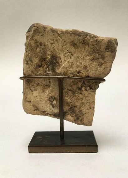 Clay plate representing a man holding a leaping...