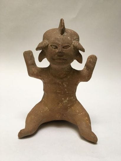 Male character in beige terracotta. He is...