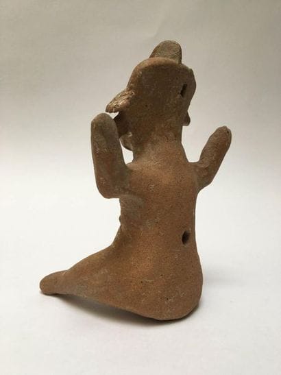 Male character in beige terracotta. He is...