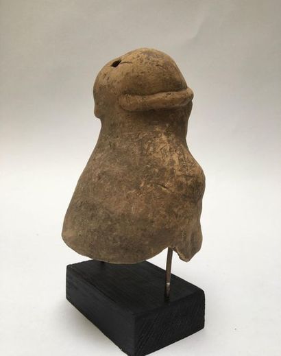 Richly adorned dignitary's head with a deformed...