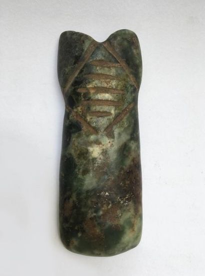 Jade axe representing a stylized character...