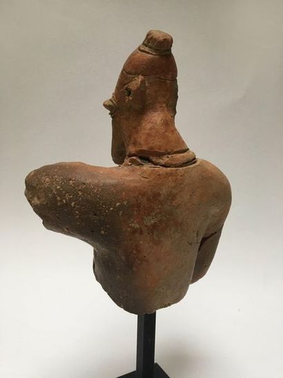 Fragmentary bust of a man with a neat beard;...