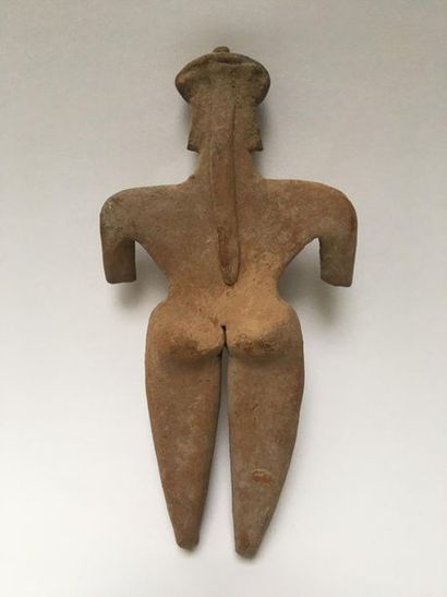 Flat orange terracotta figurine representing...