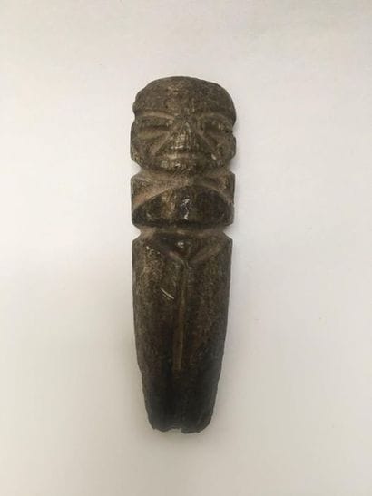 Monolithic standing figure in dark green...