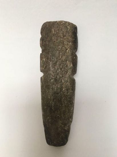 Monolithic standing figure in dark green...