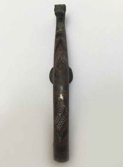 Bronze fibula inlaid with a semi of silver...