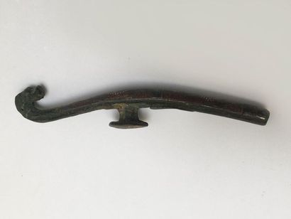 Bronze fibula inlaid with a semi of silver...