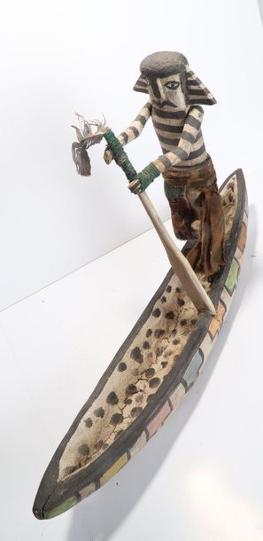 Decorative doll represented on a canoe, made...