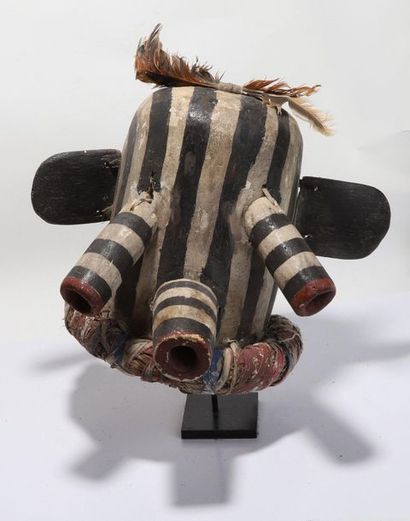 Decorative mask having a head with cylindrical...