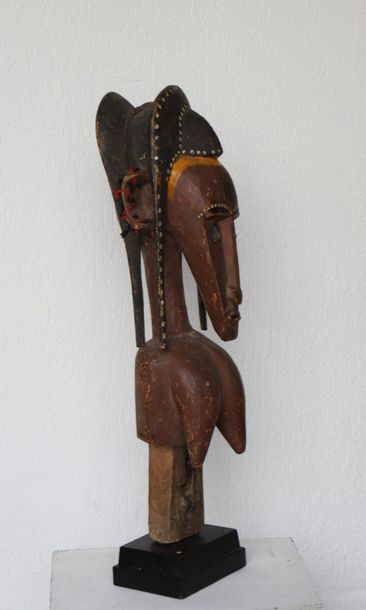 Puppet with a female bust with an elongated...