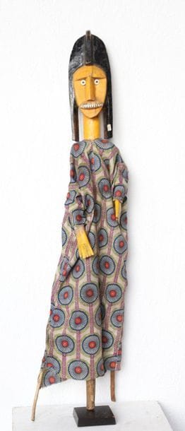 Puppet presenting a woman with an elongated...