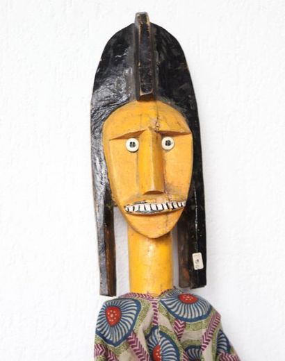 Puppet presenting a woman with an elongated...