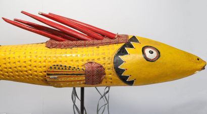 Puppet presenting a brightly coloured fish.

Polychrome...