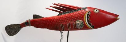 Puppet presenting a brightly coloured fish.

Polychrome...