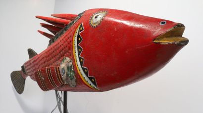Puppet presenting a brightly coloured fish.

Polychrome...