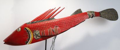 Puppet presenting a brightly coloured fish.

Polychrome...