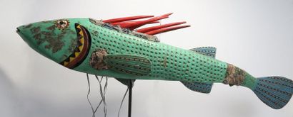 Puppet presenting a brightly coloured fish.

Polychrome...