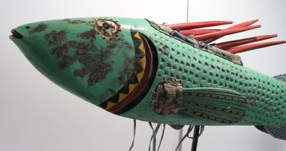 Puppet presenting a brightly coloured fish.

Polychrome...