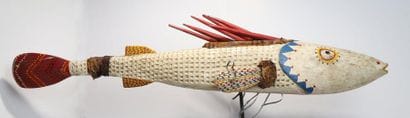 Puppet presenting a brightly coloured fish.

Polychrome...