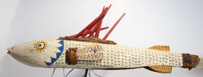 Puppet presenting a brightly coloured fish.

Polychrome...