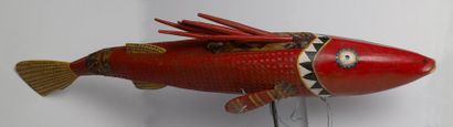 Puppet presenting a brightly coloured fish.

Polychrome...