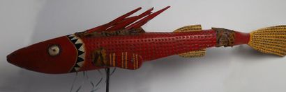 Puppet presenting a brightly coloured fish.

Polychrome...