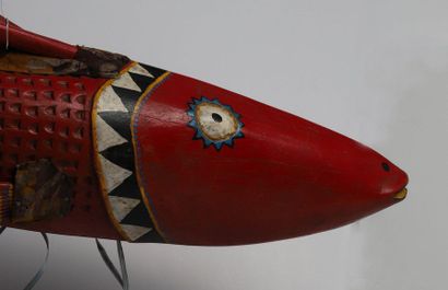 Puppet presenting a brightly coloured fish.

Polychrome...