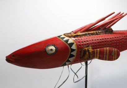 Puppet presenting a brightly coloured fish.

Polychrome...
