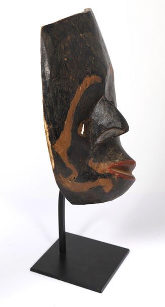 Wooden mask with a polychrome patina and...