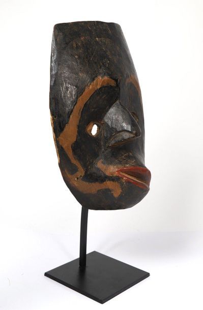 Wooden mask with a polychrome patina and...