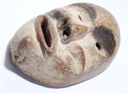 Decorative mask with a deformed face 
 
Wood,...