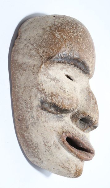 Decorative mask with a deformed face 
 
Wood,...