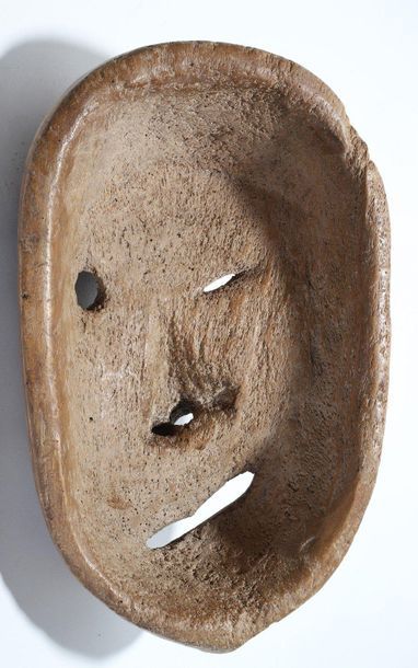 Decorative mask with a deformed face 
 
Wood,...