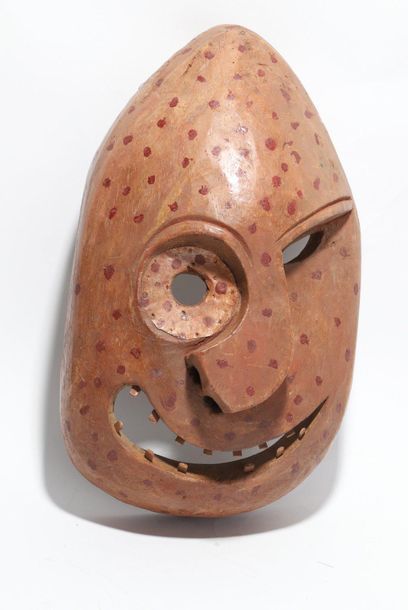 Decorative mask with a deformed face 
 
Wood,...